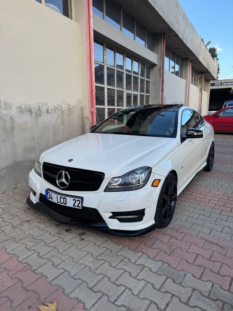 Outdoor front three-quarter photo of a white coupe used as an input reference